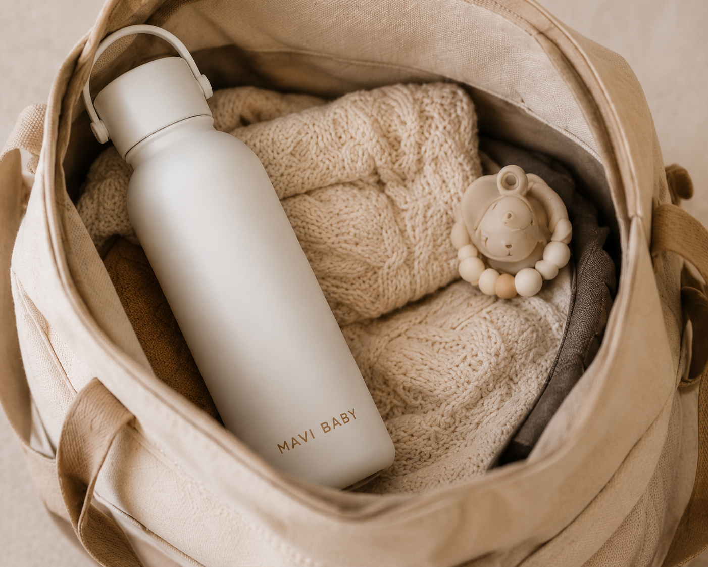 Mavi Baby Thermos packed inside a diaper bag with baby blanket and teether