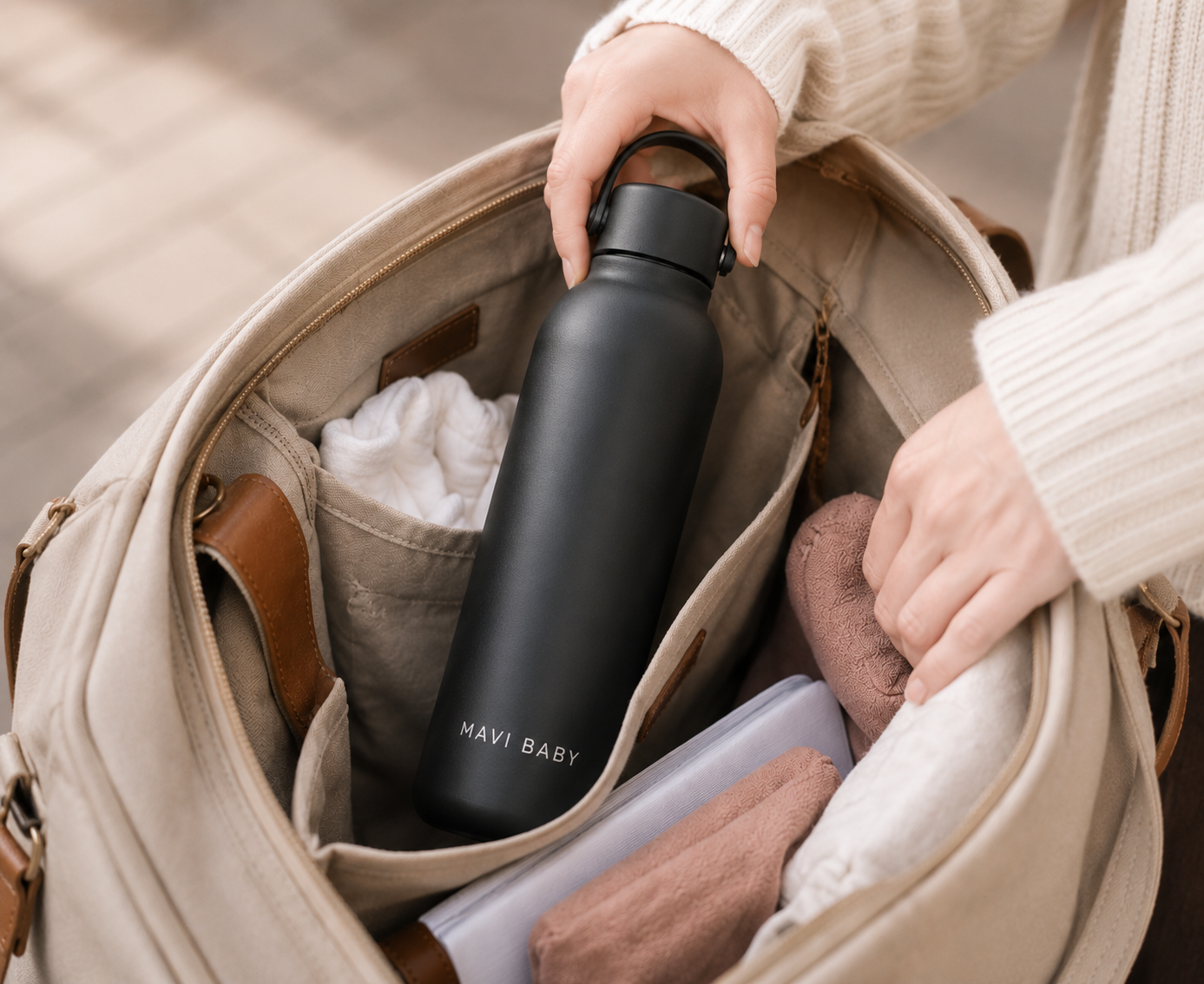 Mavi Baby Thermos being packed into a diaper bag — insulated baby bottle water warmer for feeds on the go